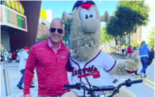 Adam Zimmerman, senior vice president of marketing and content for the Atlanta Braves, poses with the team’s beloved mascot Blooper.